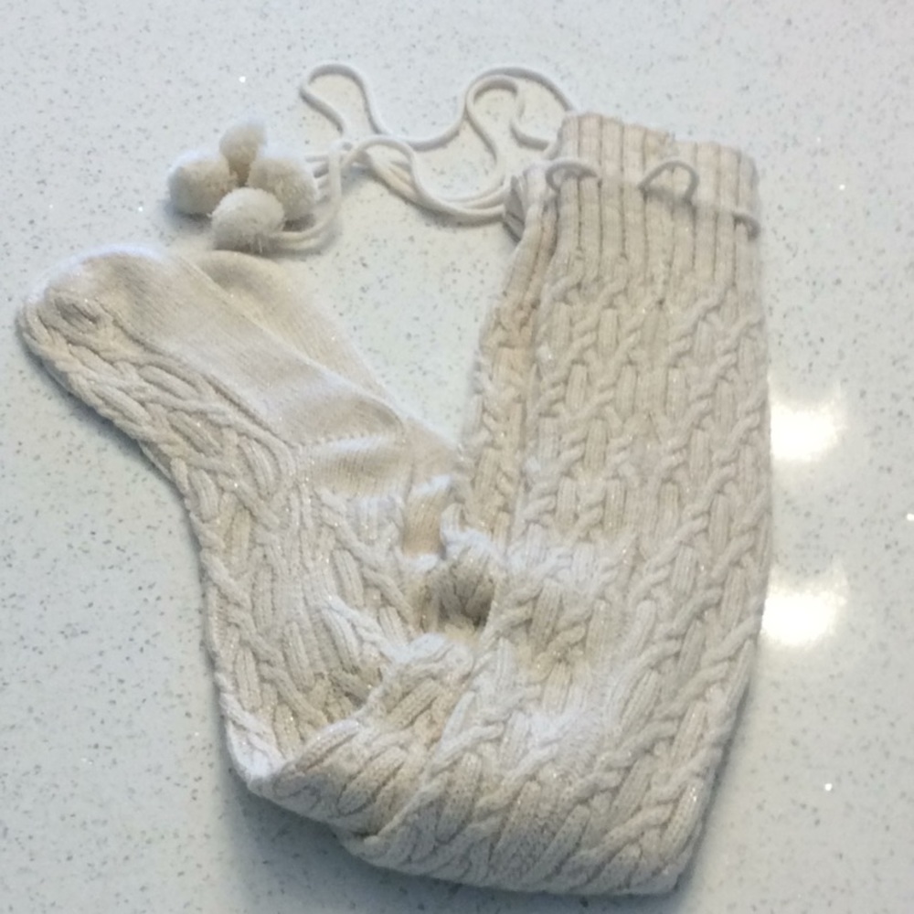 Tall Ugg socks with pom poms and gold thread.